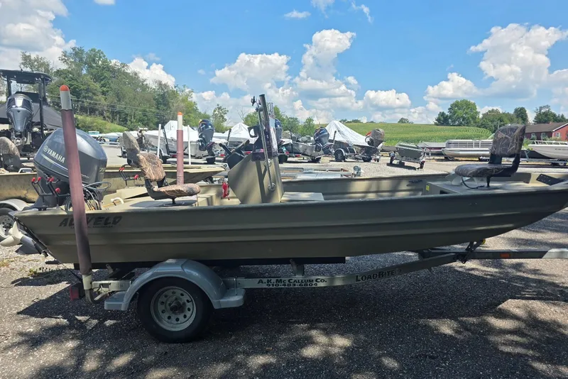 The Image of 2017 Alweld 1756VCC Angler boat on trailer, parked outdoors under a blue sky. - 0
