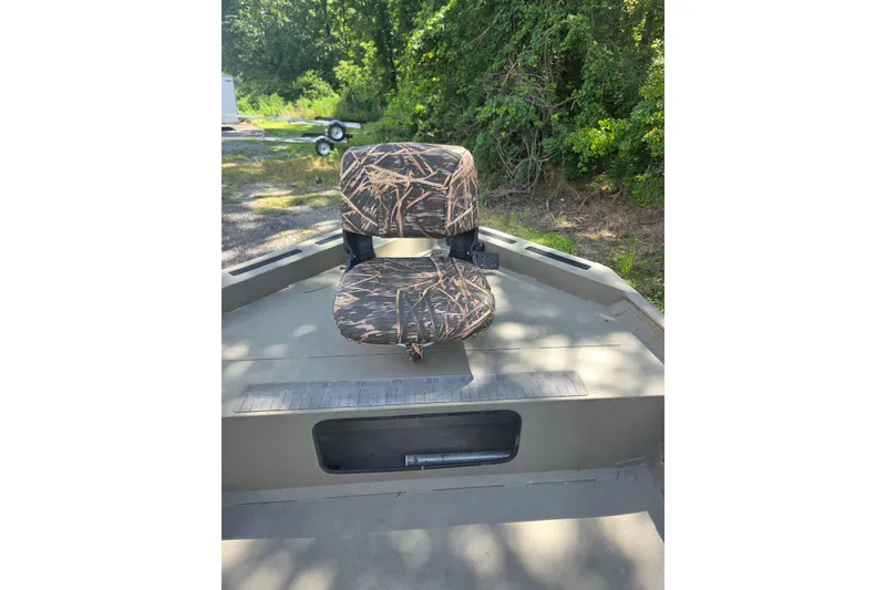 Slide: The Image of 2017 Alweld 1756VCC Angler boat with camo seat, surrounded by greenery. - 7