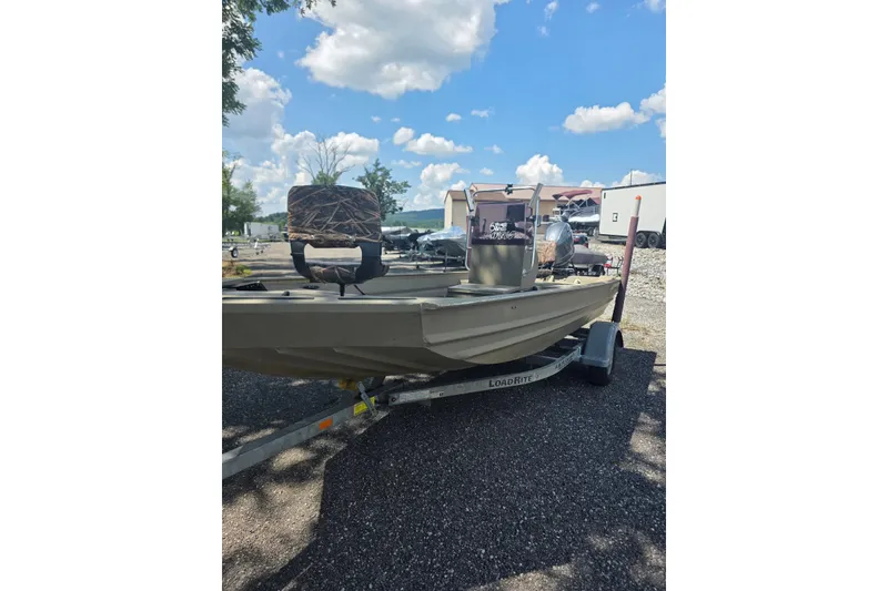Slide: The Image of 2017 Alweld 1756VCC Angler boat on trailer under blue sky. - 1