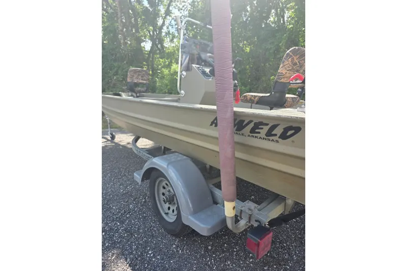 Slide: The Image of 2017 Alweld 1756VCC Angler boat on trailer, parked outdoors. - 2
