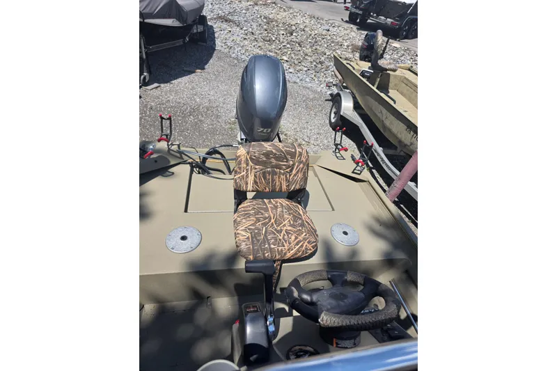 Slide: The Image of 2017 Alweld 1756VCC Angler boat interior with camo seat and steering wheel. - 9