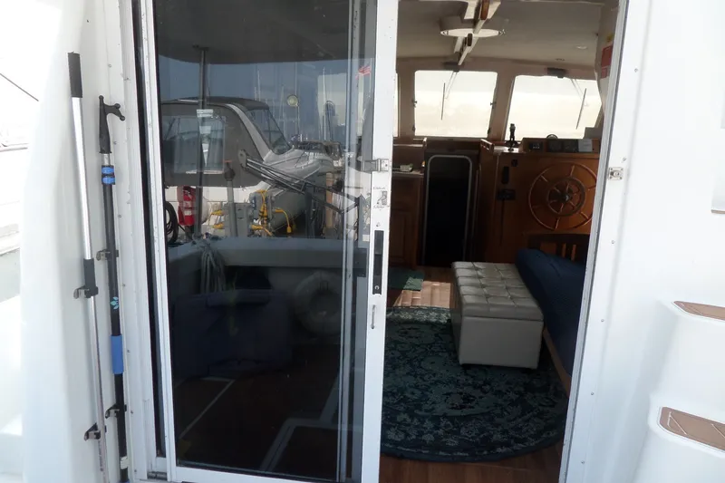 Slide: The Image of Interior view of 1997 Mainship 350 Trawler, showcasing helm and seating area. - 71