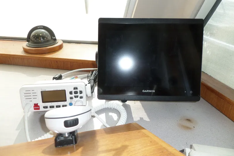 Slide: The Image of Navigation equipment on 1997 Mainship 350 Trawler, featuring Garmin display and Icom radio. - 41
