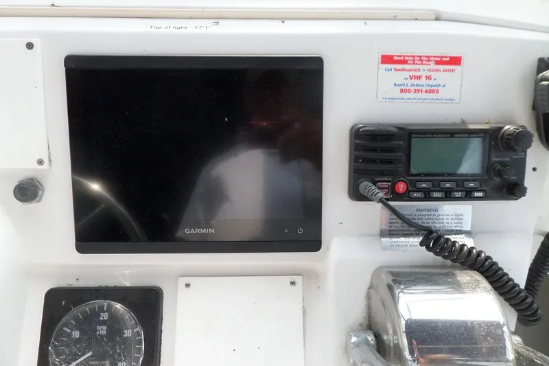 Slide: The Image of 1997 Mainship 350 Trawler dashboard with Garmin display and radio equipment. - 82