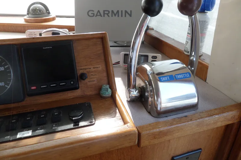 Slide: The Image of 1997 Mainship 350 Trawler helm with Garmin navigation and throttle controls. - 44