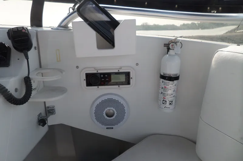Slide: The Image of Interior of a 1997 Mainship 350 Trawler with radio, speaker, and fire extinguisher. - 84