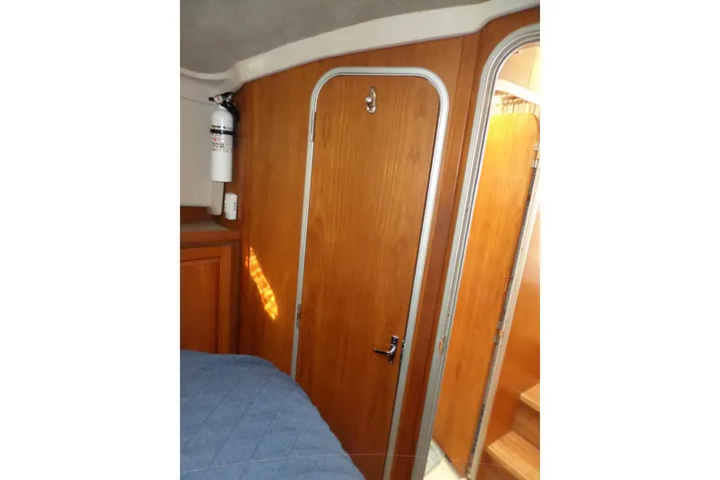 Slide: The Image of Interior of 1997 Mainship 350 Trawler with wooden door and fire extinguisher. - 25