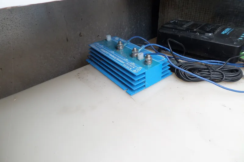 Slide: The Image of Blue battery isolator on 1997 Mainship 350 Trawler, with coiled cables nearby. - 65