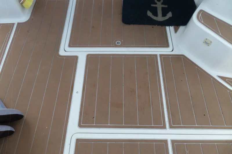 Slide: The Image of Deck of 1997 Mainship 350 Trawler with brown panels and anchor-themed mat. - 72