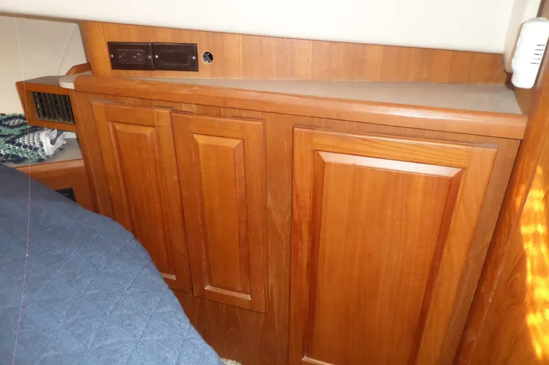 Slide: The Image of Wooden cabinetry inside a 1997 Mainship 350 Trawler, showcasing elegant design and storage. - 24