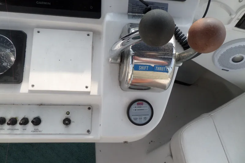 Slide: The Image of 1997 Mainship 350 Trawler helm controls with shift and throttle levers. - 83