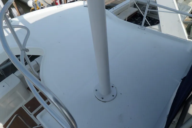 Slide: The Image of 1997 Mainship 350 Trawler deck with railing and mast, docked at marina. - 73