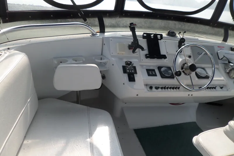 Slide: The Image of 1997 Mainship 350 Trawler helm with steering wheel and control panel. - 77