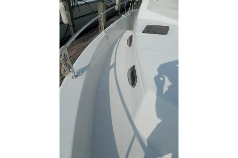 Slide: The Image of 1997 Mainship 350 Trawler deck view with railing and cleats. - 57
