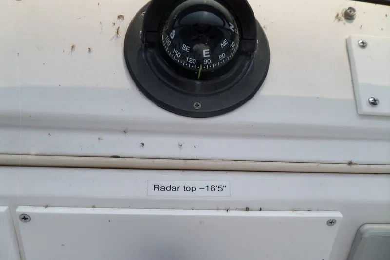 Slide: The Image of Compass and radar height label on 1997 Mainship 350 Trawler dashboard. - 85