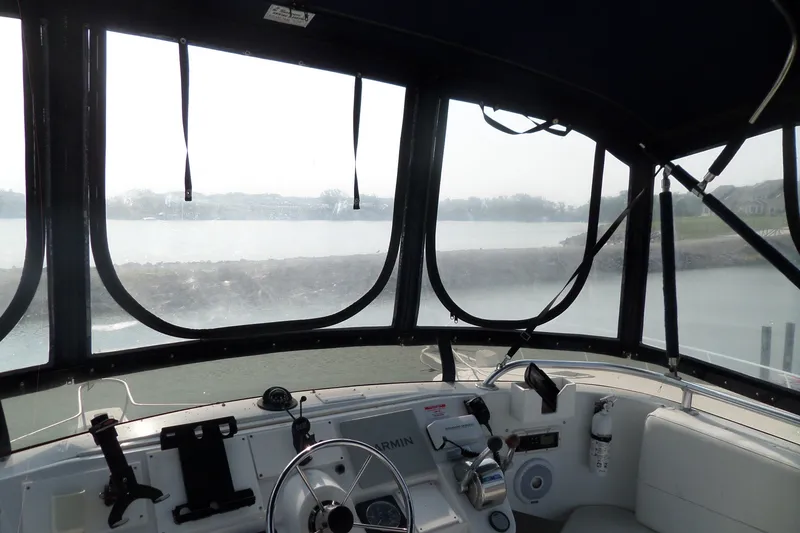 Slide: The Image of Interior view of 1997 Mainship 350 Trawler helm with waterway in background. - 79