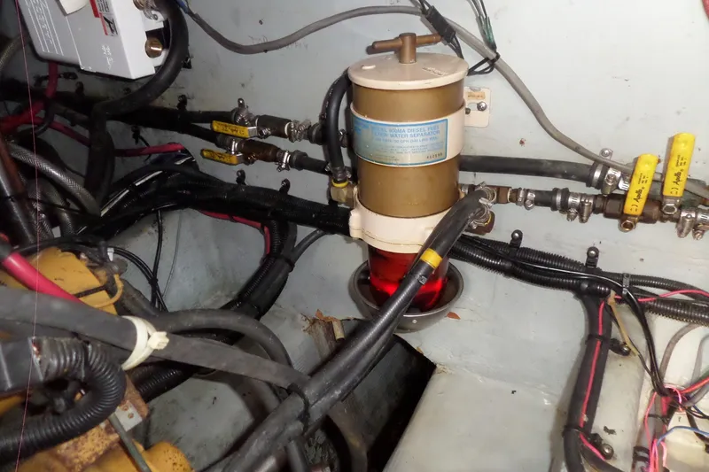 Slide: The Image of Engine room of 1997 Mainship 350 Trawler with fuel filter and wiring. - 14