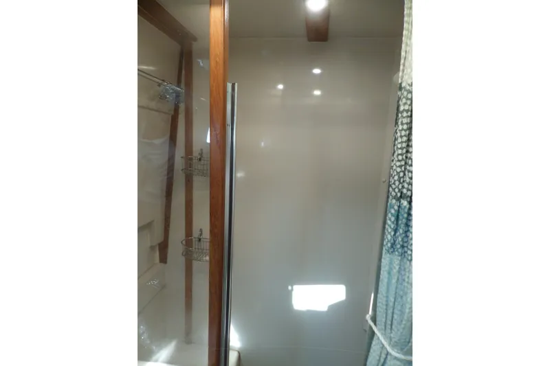 Slide: The Image of Shower area inside 1997 Mainship 350 Trawler, featuring wooden accents and modern fixtures. - 30