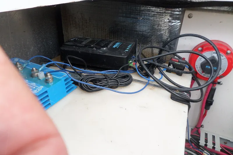 Slide: The Image of Electrical components and wiring inside a 1997 Mainship 350 Trawler boat. - 64