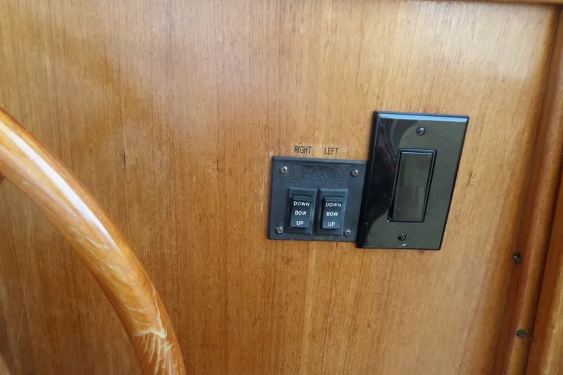 Slide: The Image of 1997 Mainship 350 Trawler control panel with switches on wooden dashboard. - 45