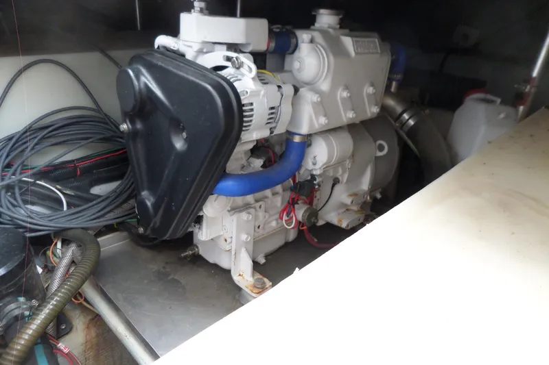 Slide: The Image of Engine compartment of a 1997 Mainship 350 Trawler, featuring wiring and mechanical components. - 66
