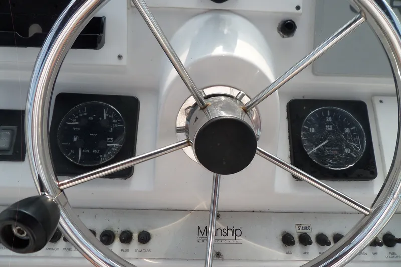 Slide: The Image of Steering wheel and dashboard of a 1997 Mainship 350 Trawler yacht. - 81