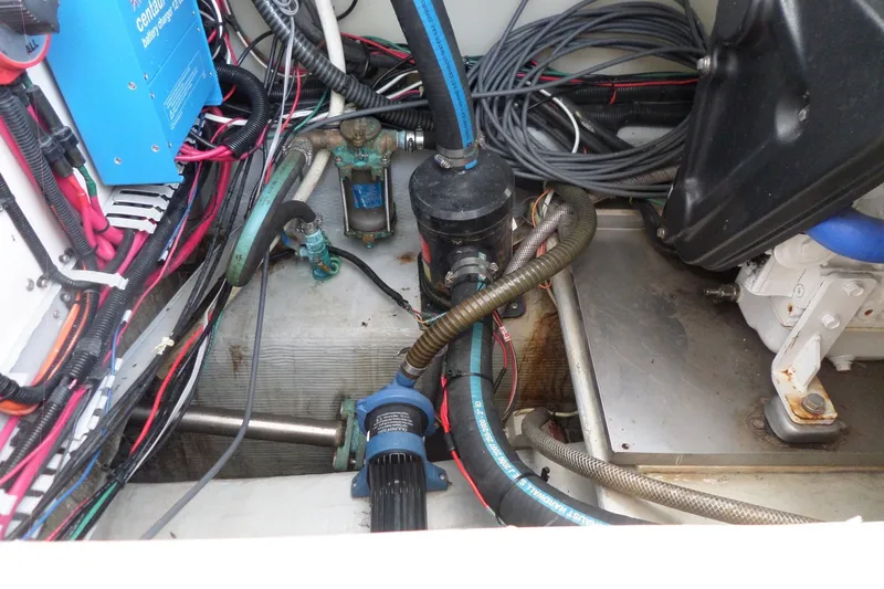 Slide: The Image of Engine compartment of a 1997 Mainship 350 Trawler with visible wiring and components. - 67