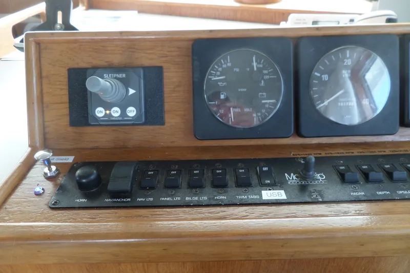 Slide: The Image of Control panel of a 1997 Mainship 350 Trawler with gauges and switches. - 42