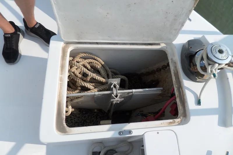 Slide: The Image of Anchor locker of a 1997 Mainship 350 Trawler with ropes and anchor chain. - 54