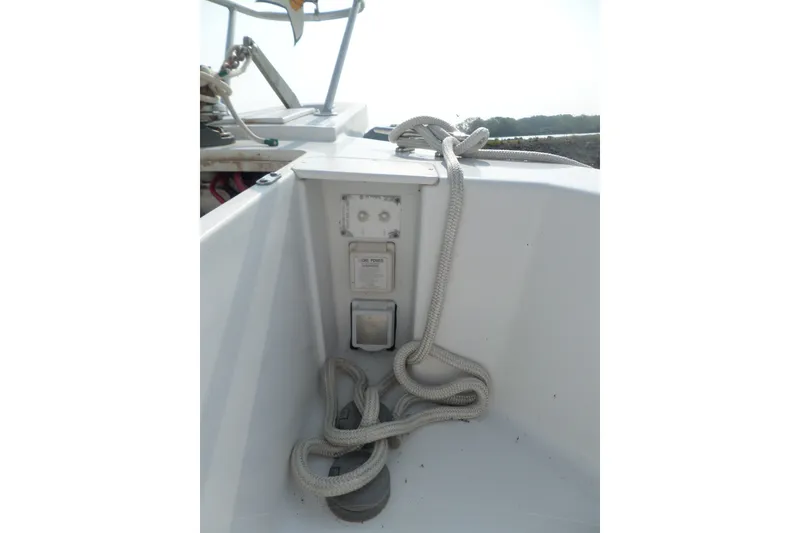Slide: The Image of 1997 Mainship 350 Trawler deck with coiled rope and power outlet. - 53