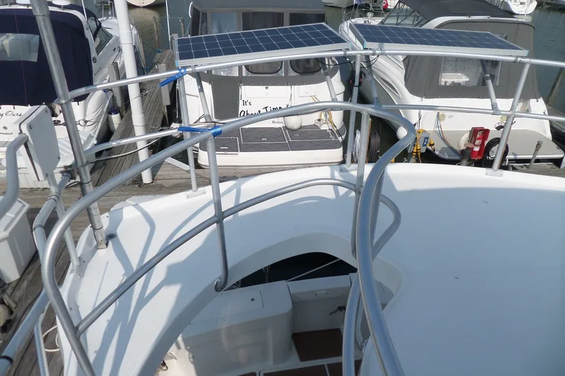 Slide: The Image of 1997 Mainship 350 Trawler with solar panels docked at a marina. - 74