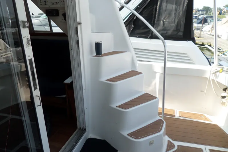 Slide: The Image of Staircase on 1997 Mainship 350 Trawler with wooden steps and railing. - 61