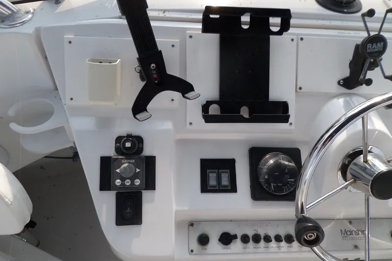 Slide: The Image of 1997 Mainship 350 Trawler helm with steering wheel, controls, and instrument panel. - 80