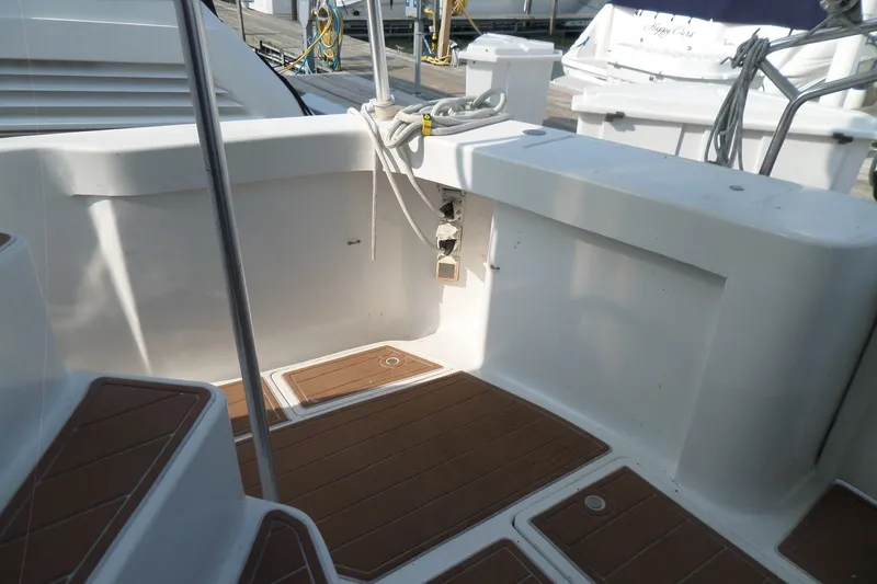 Slide: The Image of 1997 Mainship 350 Trawler deck with wood accents and dockside view. - 62