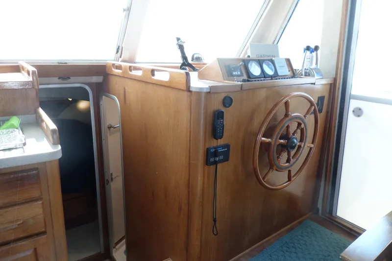 Slide: The Image of 1997 Mainship 350 Trawler helm with wooden wheel and navigation instruments. - 40