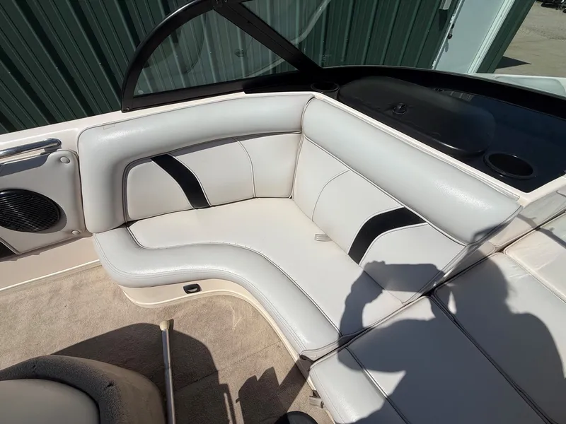 Slide: The Image of The image shows the white upholstered seating area of a boat with black accents. - 12