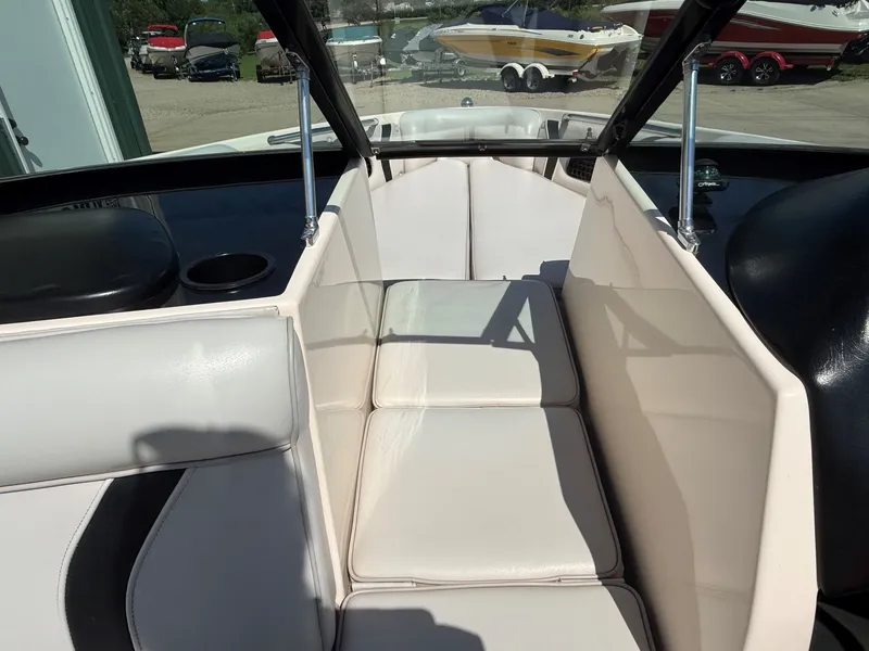 Slide: The Image of The image shows the bow area of a 1999 Supra Legacy boat with beige upholstery. - 11
