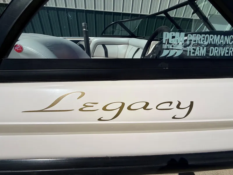 Slide: The Image of Close-up of the "Legacy" lettering on a boat's side, with a glimpse of the interior. - 6