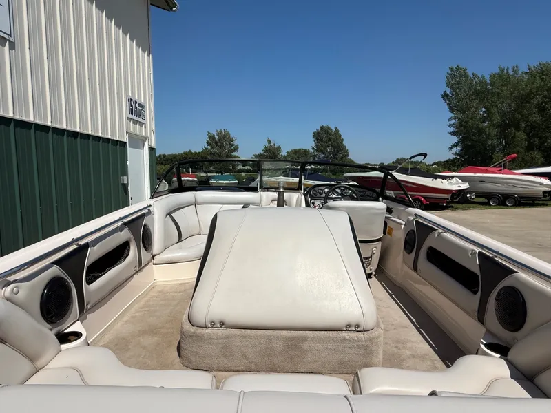 Slide: The Image of The image shows the interior of a 1999 Supra Legacy boat with white upholstery and speakers. - 8