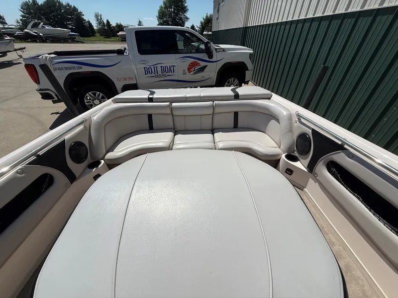 Slide: The Image of The image shows the cockpit of a 1999 Supra Legacy boat with white upholstery and speakers. - 13