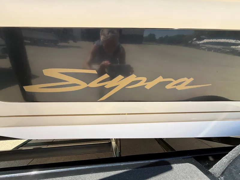 Slide: The Image of Close-up of the "Supra" logo on a boat hull. - 5