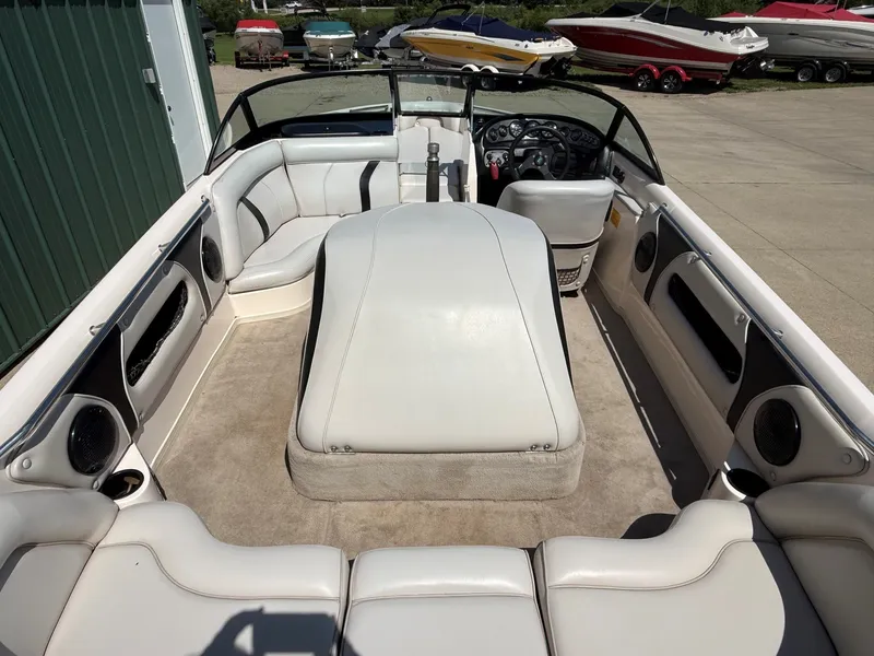 Slide: The Image of The image shows the spacious cockpit of a 1999 Supra Legacy boat with white upholstery. - 9