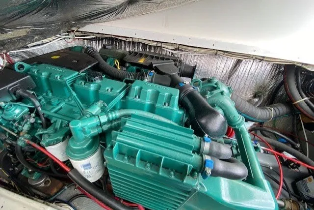 Slide: The Image of Engine compartment of a 1997 Fortier 33 boat, showcasing a well-maintained marine engine. - 5