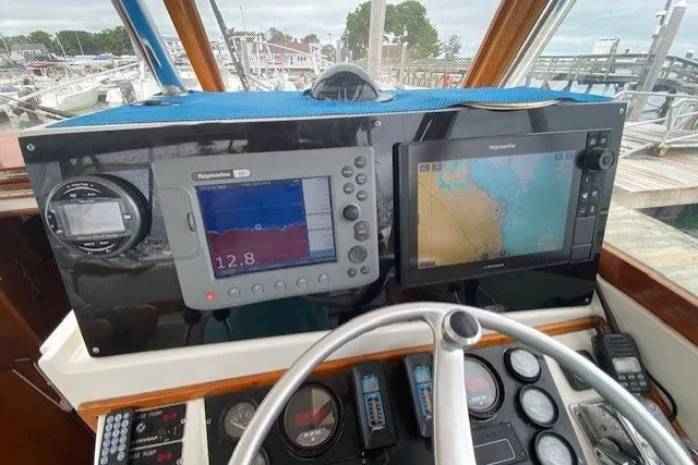 Slide: The Image of Cockpit of 1997 Fortier 33 boat with navigation equipment and steering wheel. - 11