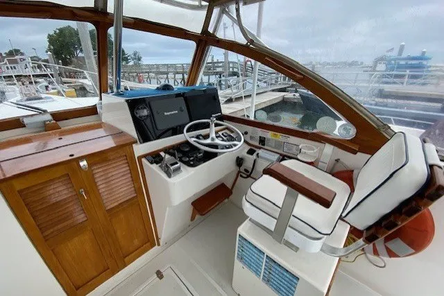 Slide: The Image of Interior of a 1997 Fortier 33 boat with wooden accents and navigation equipment. - 14