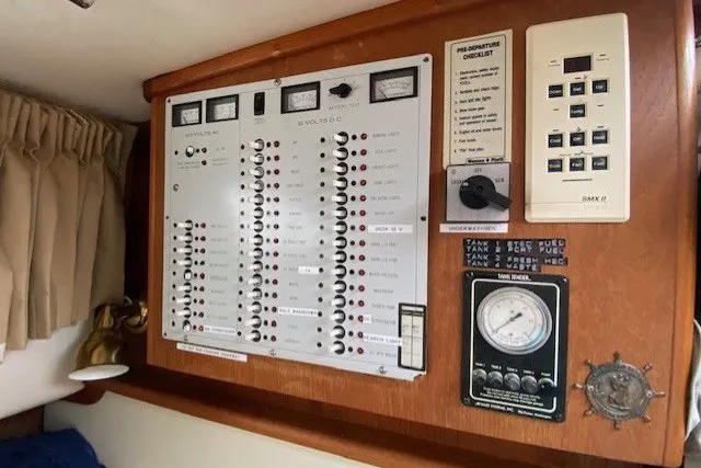 Slide: The Image of Electrical control panel inside a 1997 Fortier 33 boat, featuring gauges and switches. - 8