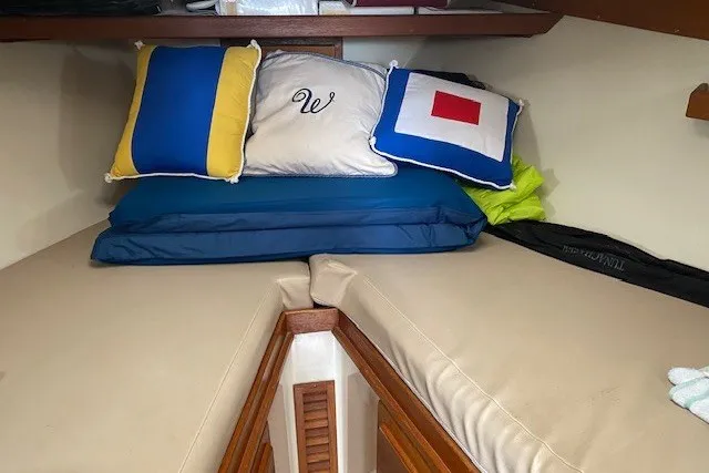 Slide: The Image of Cozy cabin interior of 1997 Fortier 33 boat with colorful pillows. - 13