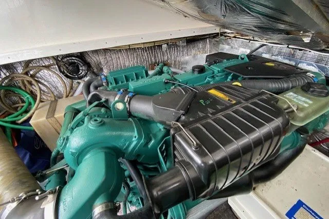 Slide: The Image of Engine compartment of a 1997 Fortier 33 boat, showcasing a well-maintained marine engine. - 7