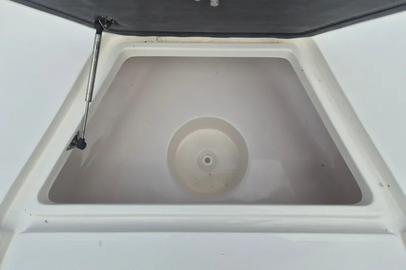 Slide: The Image of Storage compartment of 2026 Key West 230 Bay Reef boat, featuring hydraulic lift support. - 21