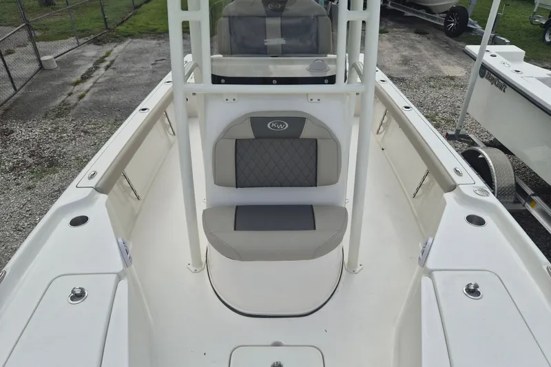 Slide: The Image of 2026 Key West 230 Bay Reef boat interior with cushioned seating and storage compartments. - 25